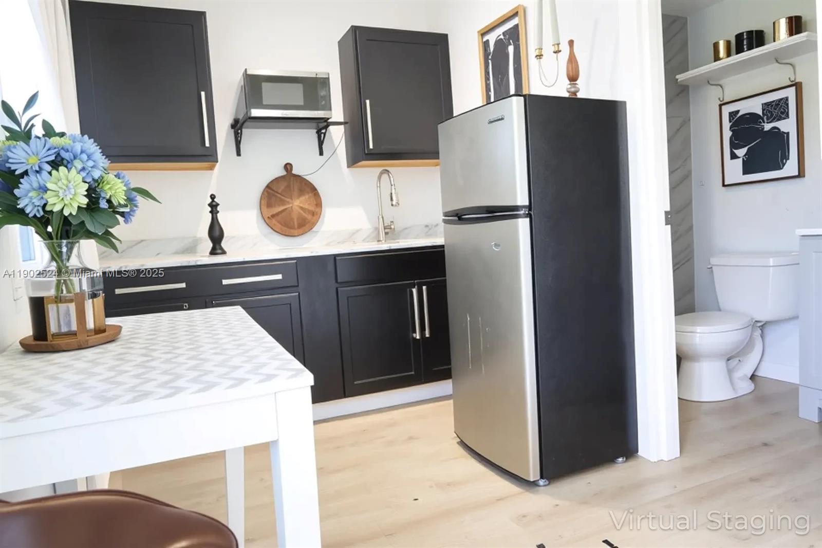 3216 22nd Street Southwest Lehigh Acres, FL 33976 - Photo 21 of 28 a kitchen with stainless steel appliances granite countertop a refrigerator and a sink