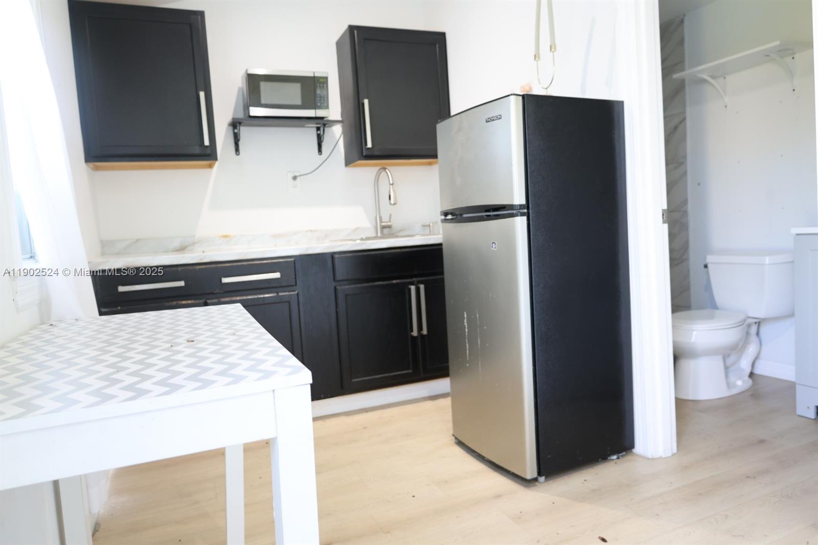 3216 22nd Street Southwest Lehigh Acres, FL 33976 - Photo 22 of 28 a kitchen with stainless steel appliances a refrigerator and a sink
