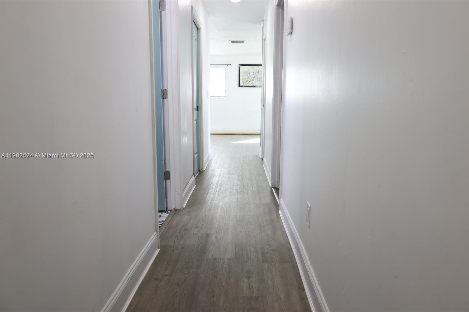 3216 22nd Street Southwest Lehigh Acres, FL 33976 - Photo 23 of 28 a view of a hallway with wooden floor