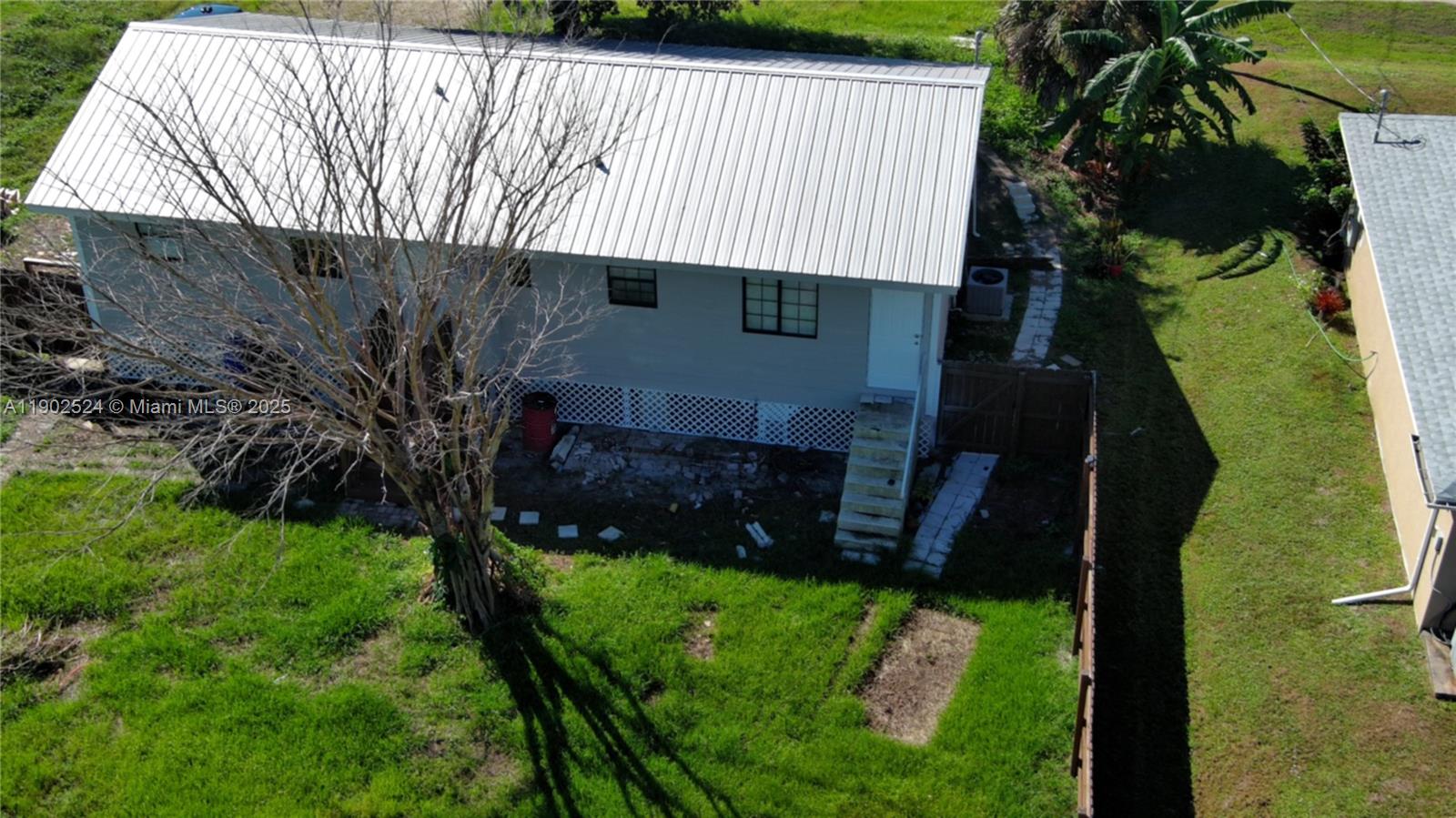 3216 22nd Street Southwest Lehigh Acres, FL 33976 - Photo 27 of 28 a house view with a backyard space