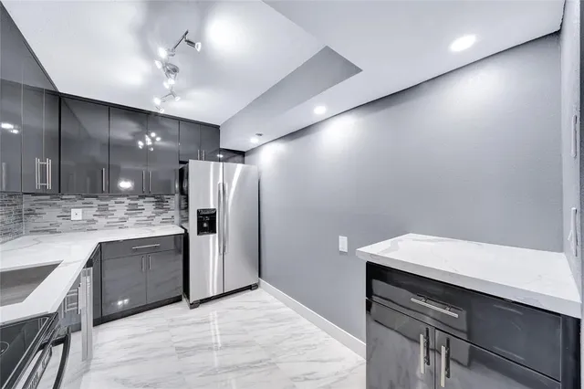a kitchen with a sink and refrigerator