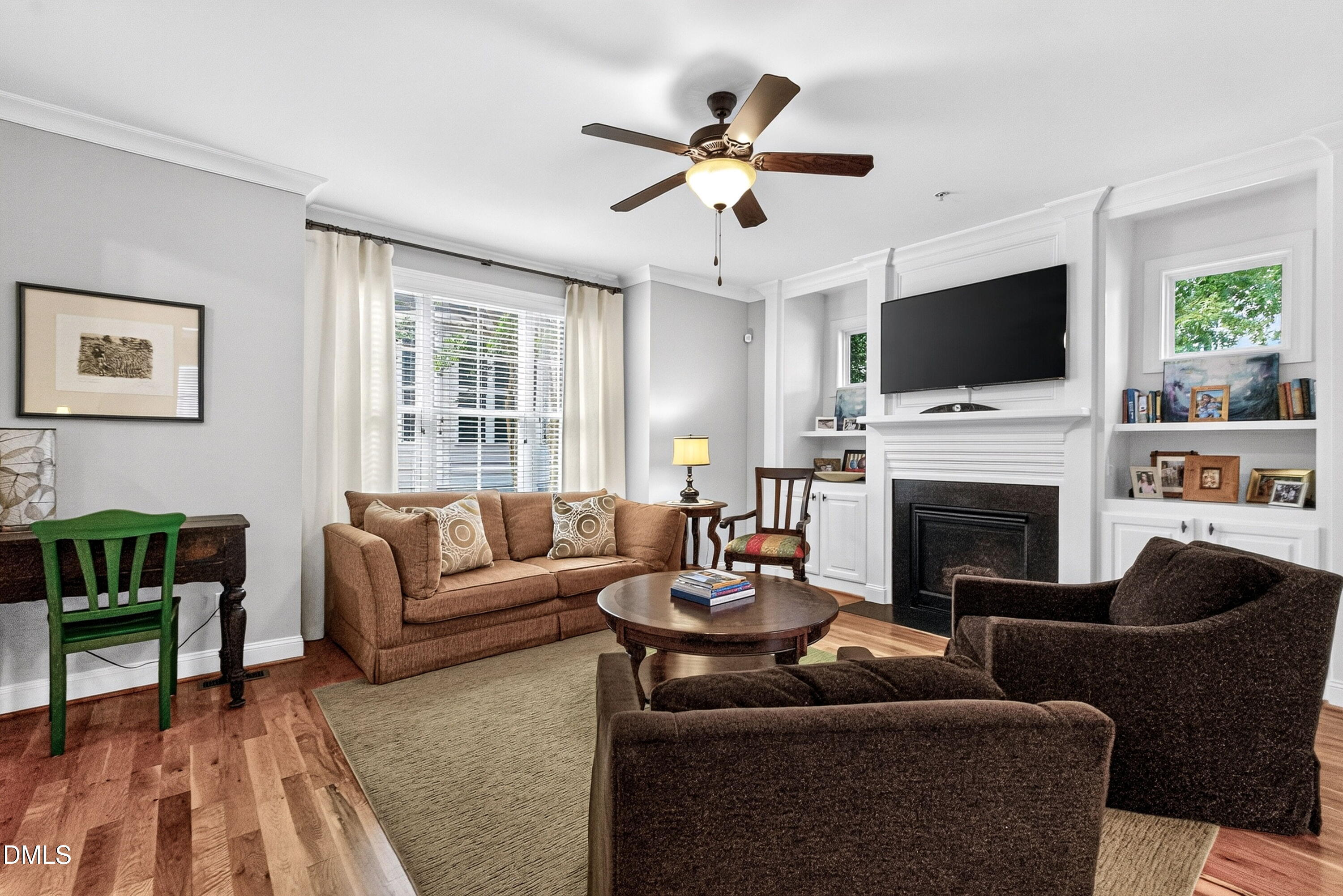 2745 Oberlin Road, Unit 103 Raleigh, NC 27608 - Photo 9 of 23 a living room with furniture a fireplace and a flat screen tv