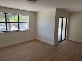 610 South Park Road, Unit 261 Hollywood, FL 33021 - Photo 12 of 13 an empty room with wooden floor and windows
