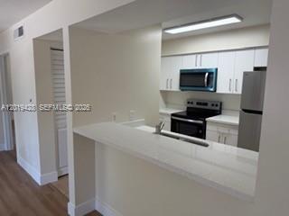 610 South Park Road, Unit 261 Hollywood, FL 33021 - Photo 9 of 13 a kitchen with a refrigerator and a sink
