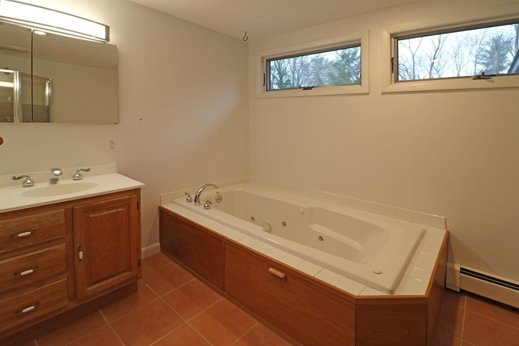 20 Under Pin Hill Road Harvard, MA 01451 - Photo 19 of 41 a bathroom with a tub sink and mirror