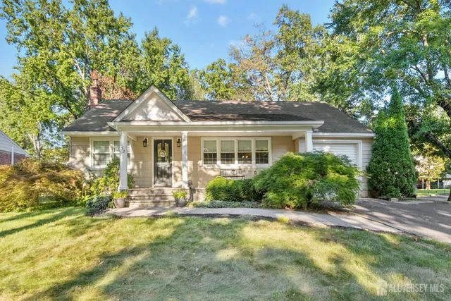 a front view of a house with a yard table and chairs