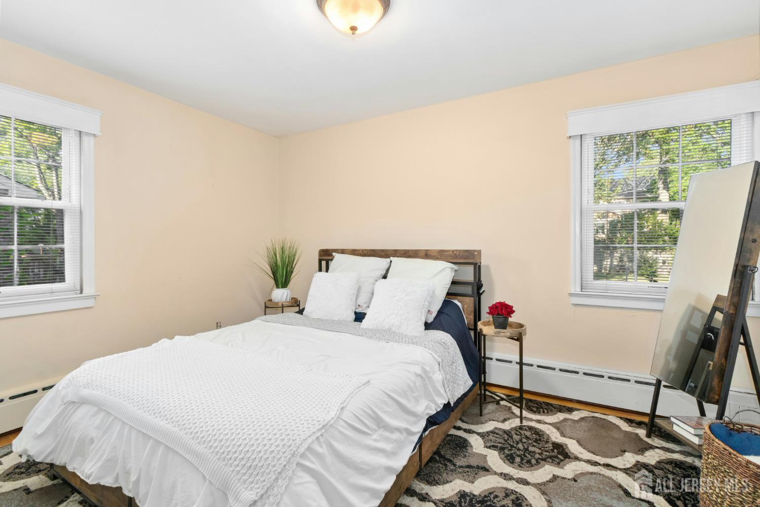 52 Brookside Terrace Clark, NJ 07066 - Photo 12 of 26 a bed sitting in a bedroom next to a window