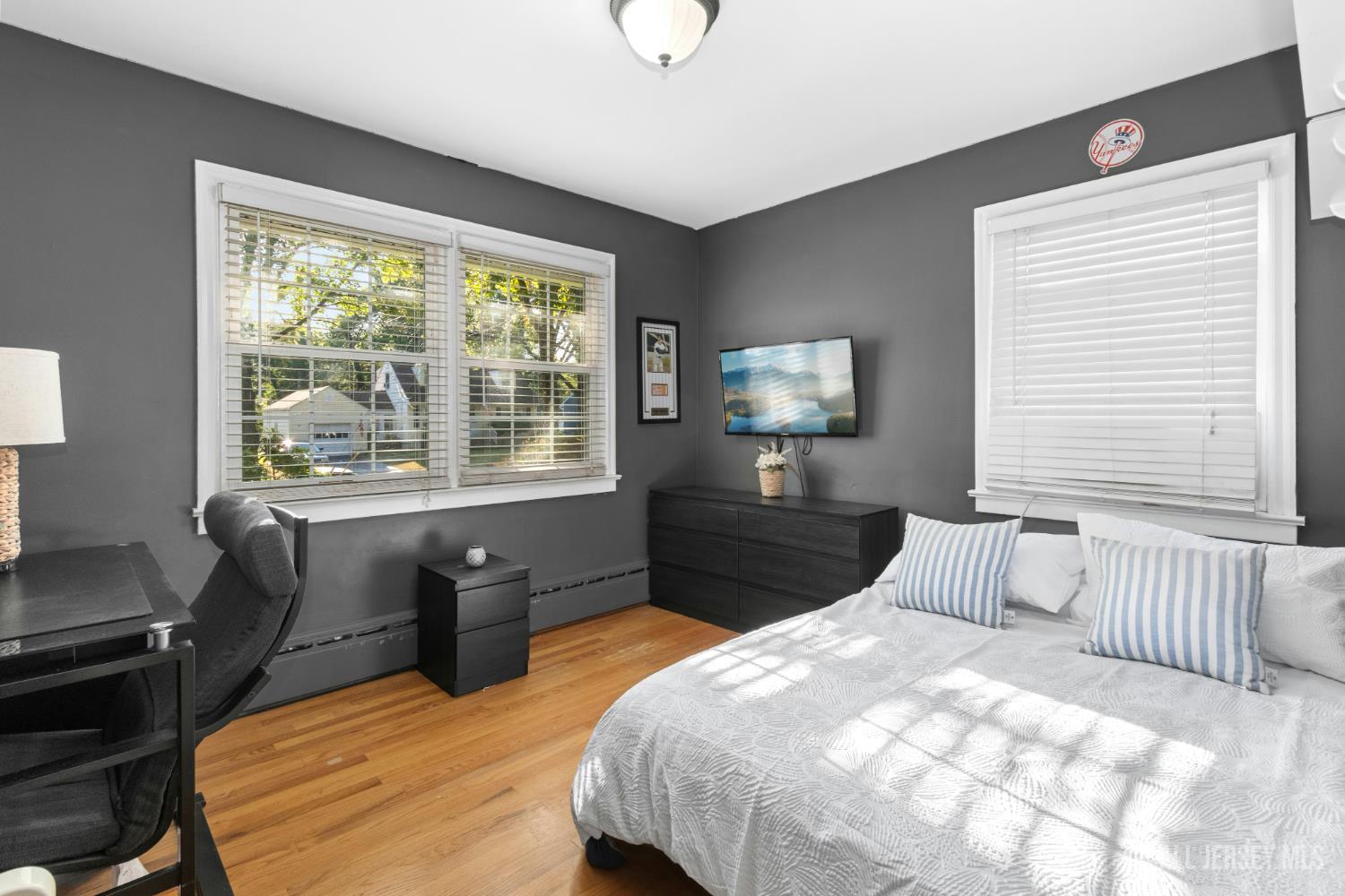 52 Brookside Terrace Clark, NJ 07066 - Photo 13 of 26 a bedroom with a large bed and wooden floor