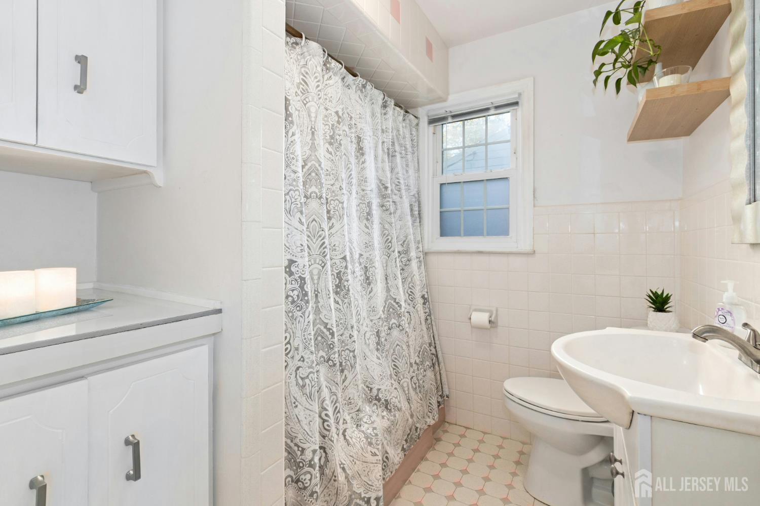 52 Brookside Terrace Clark, NJ 07066 - Photo 14 of 26 a white toilet sitting next to a bathroom sink