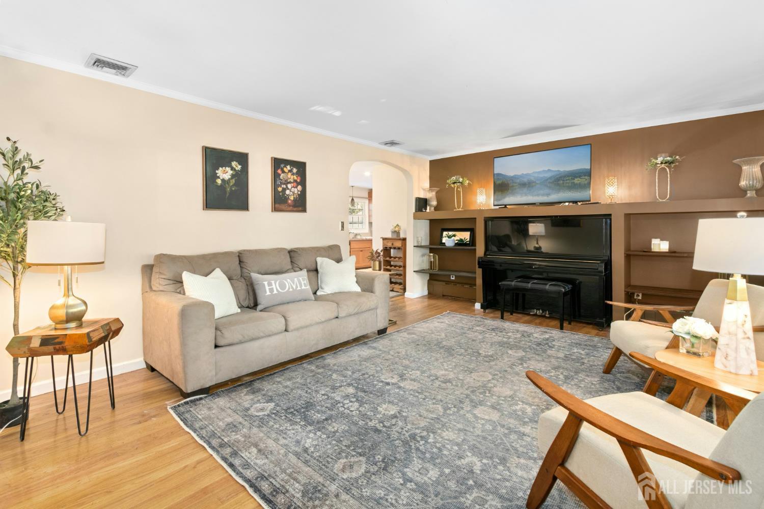 52 Brookside Terrace Clark, NJ 07066 - Photo 2 of 26 a living room with furniture a lamp and a fireplace