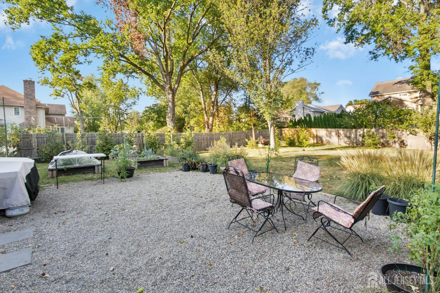 52 Brookside Terrace Clark, NJ 07066 - Photo 23 of 26 a view of a backyard with table and chairs and a fire pit