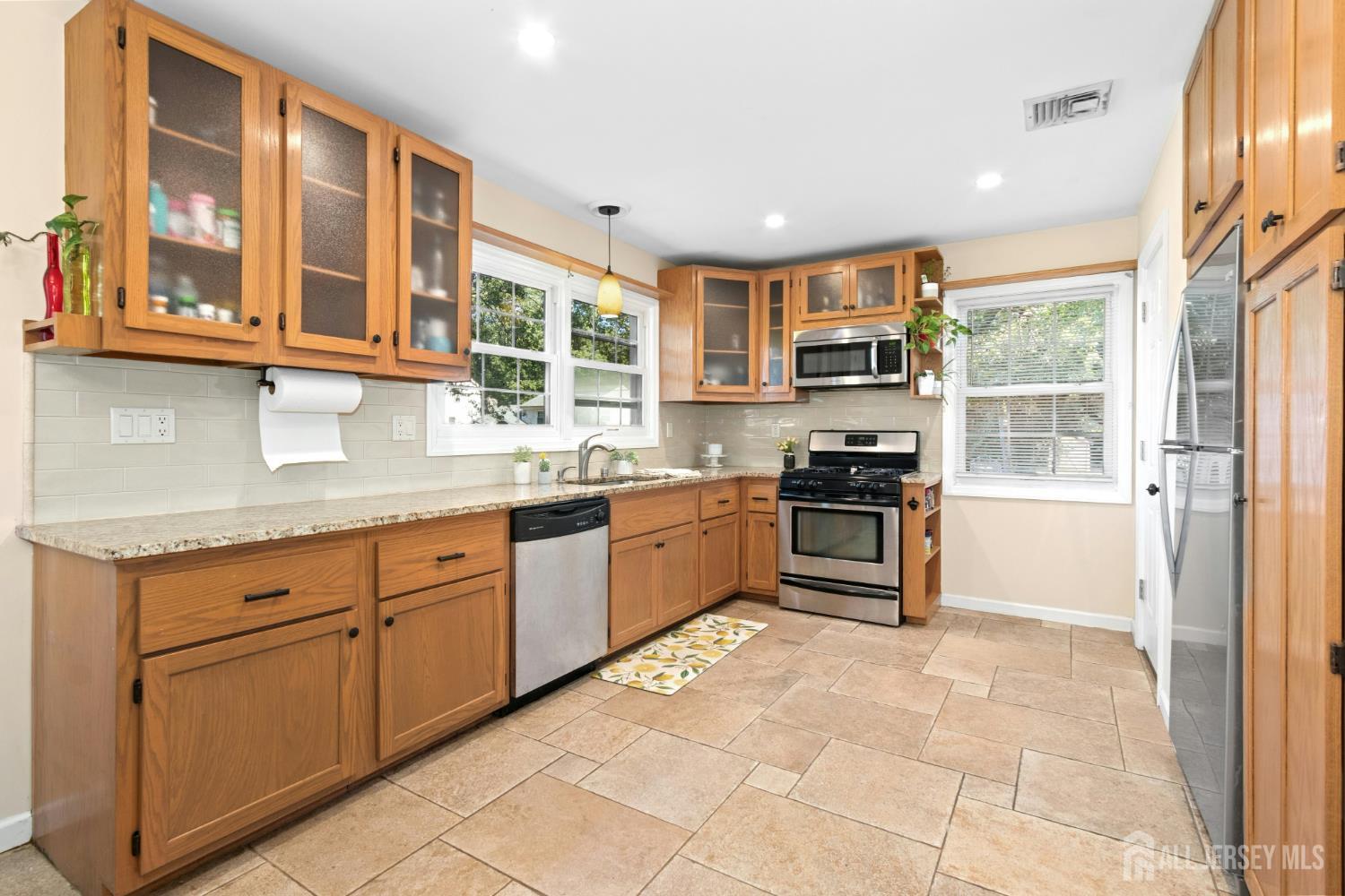 52 Brookside Terrace Clark, NJ 07066 - Photo 7 of 26 a kitchen with granite countertop a stove a sink and a microwave