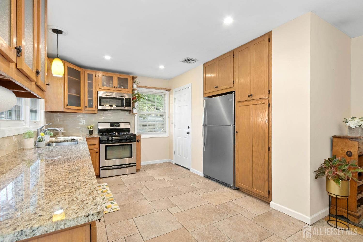 52 Brookside Terrace Clark, NJ 07066 - Photo 8 of 26 a kitchen with stainless steel appliances a refrigerator and a stove top oven
