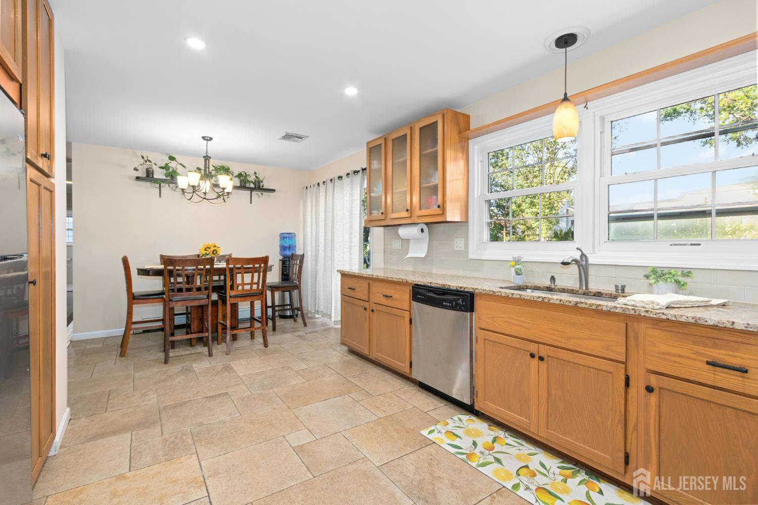 52 Brookside Terrace Clark, NJ 07066 - Photo 9 of 26 a kitchen with granite countertop a sink dining table and chairs