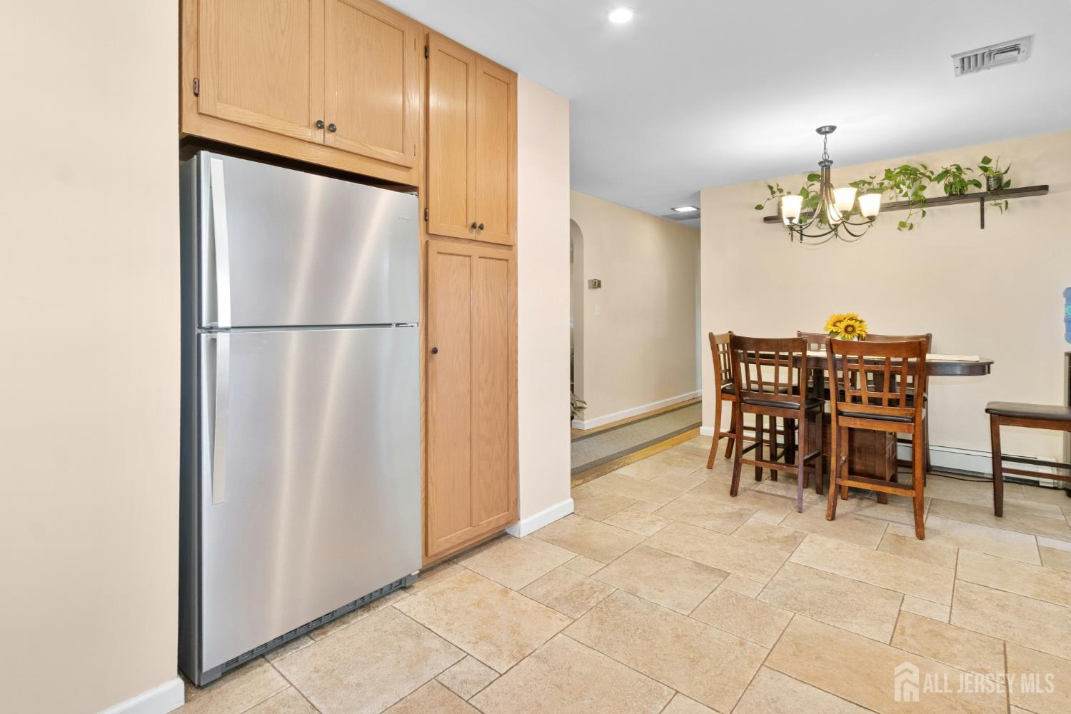 52 Brookside Terrace Clark, NJ 07066 - Photo 10 of 26 a close view of dining table chair and refrigerator