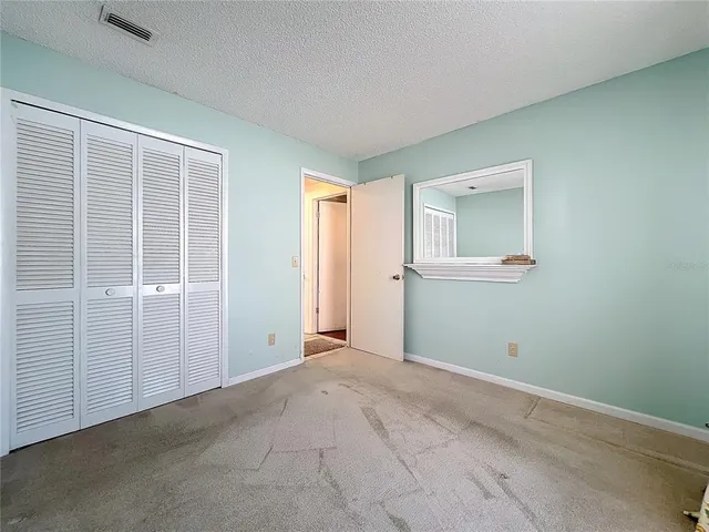 a view of a livingroom with a ceiling fan and wooden floor