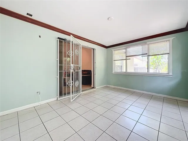 an aerial view of a city with lots of residential buildings ocean and mountain view in back