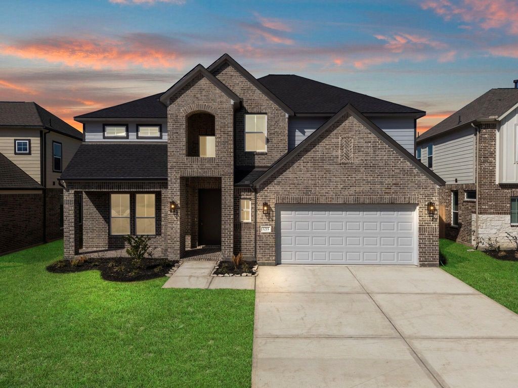 1972 Golden Spruce Lane Conroe, TX 77301 - Photo 1 of 19 a front view of a house with a yard