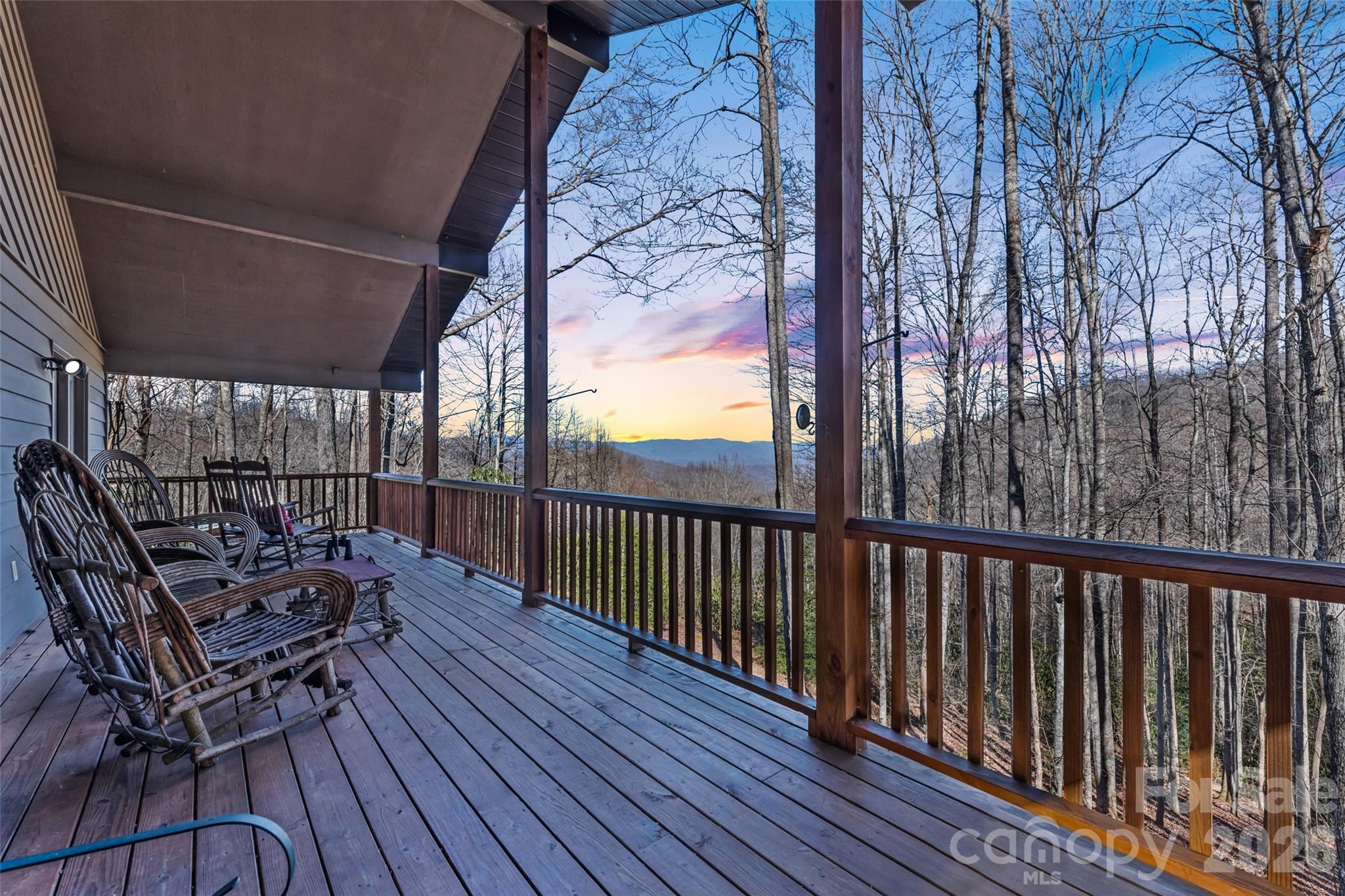 a balcony with wooden floor and outdoor seating