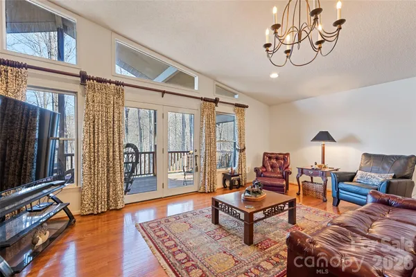 a living room with furniture a flat screen tv and a window