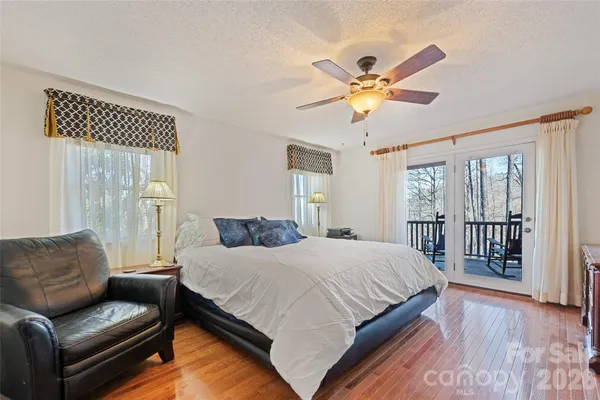 a bedroom with a bed couch and a window