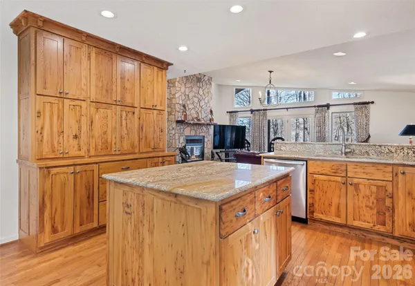a kitchen with stainless steel appliances granite countertop a sink and cabinets