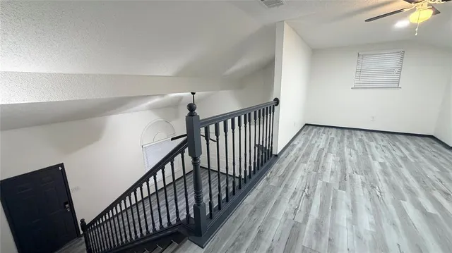 a view of a hallway with wooden floor