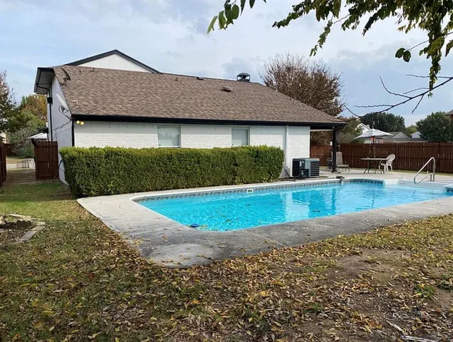 a view of a house with a yard and sitting area