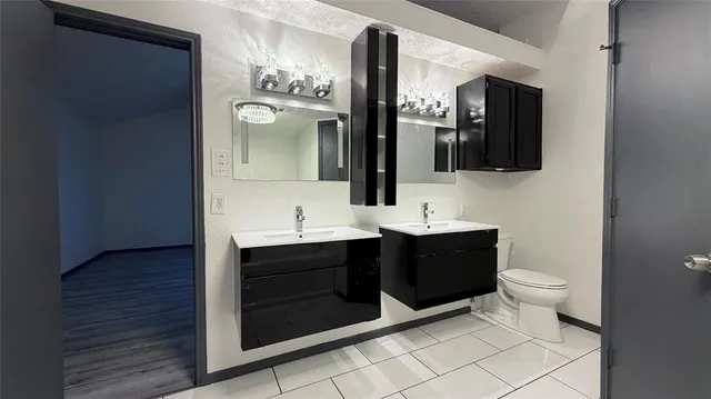 a bathroom with a sink vanity and toilet