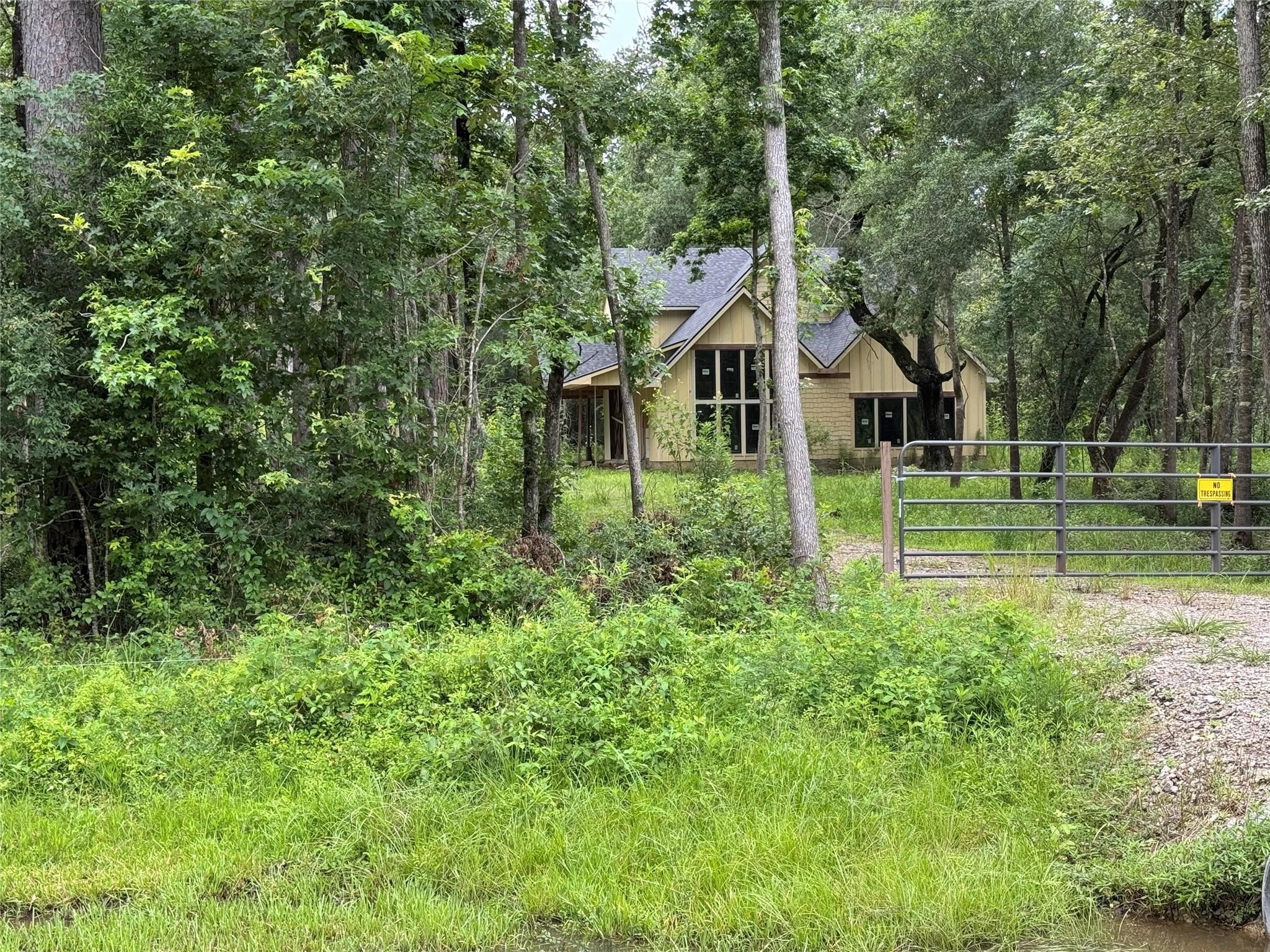 9813 Fm 563 Road Liberty, TX 77575 - Photo 2 of 8 An unfinished home sits tucked among mature trees, providing a rare opportunity to complete and customize your dream residence.