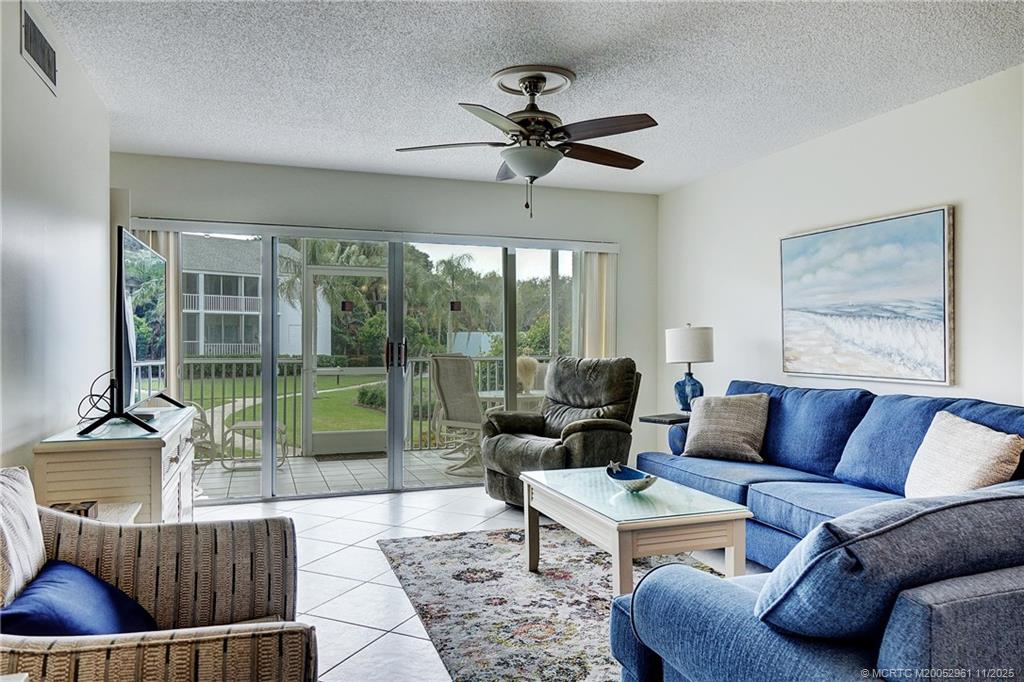 1550 Northeast Ocean Boulevard, Unit B101 Stuart, FL 34996 - Photo 12 of 32 a living room with furniture and a floor to ceiling window