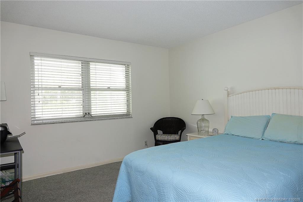 1550 Northeast Ocean Boulevard, Unit B101 Stuart, FL 34996 - Photo 15 of 32 a bedroom with a bed and window