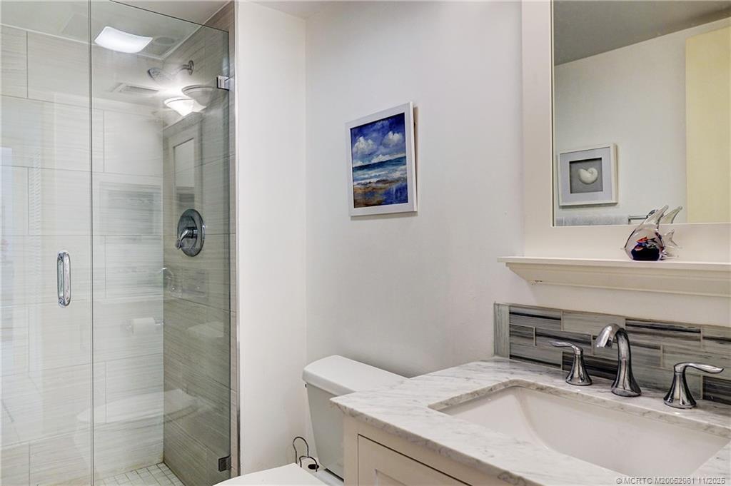 1550 Northeast Ocean Boulevard, Unit B101 Stuart, FL 34996 - Photo 16 of 32 a bathroom with a sink a toilet and shower