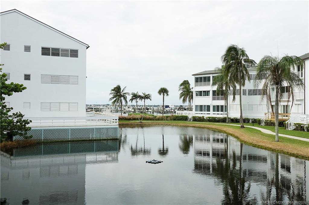 1550 Northeast Ocean Boulevard, Unit B101 Stuart, FL 34996 - Photo 24 of 32 a view of a swimming pool with outdoor seating and a yard