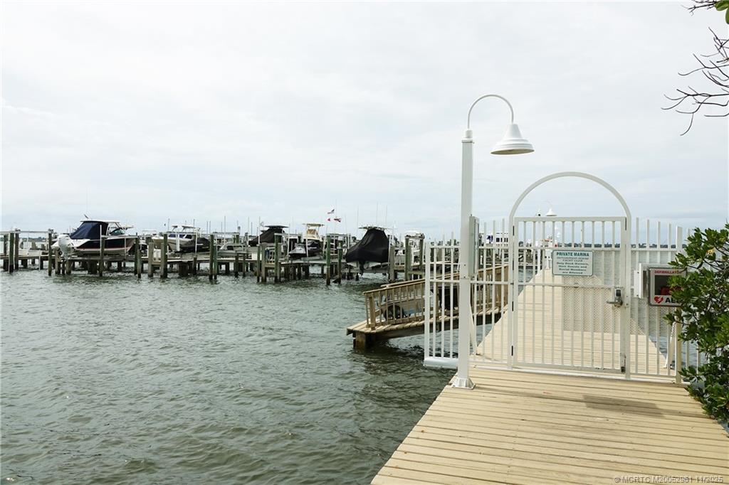 1550 Northeast Ocean Boulevard, Unit B101 Stuart, FL 34996 - Photo 28 of 32 a roof deck with table and chairs a barbeque