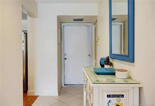 a kitchen with a dining table chairs microwave and stove