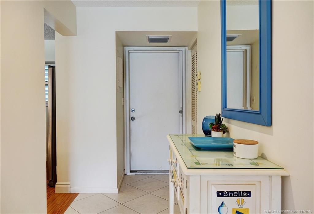 1550 Northeast Ocean Boulevard, Unit B101 Stuart, FL 34996 - Photo 7 of 32 a bathroom with a granite countertop sink and a mirror