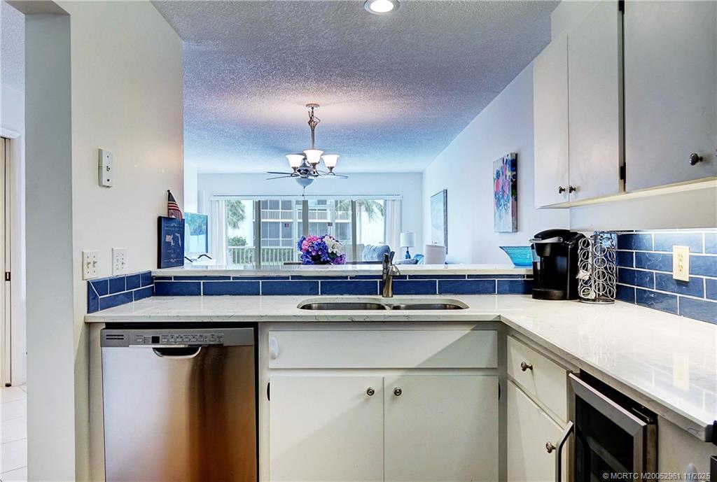 1550 Northeast Ocean Boulevard, Unit B101 Stuart, FL 34996 - Photo 8 of 32 a kitchen with a sink and cabinets