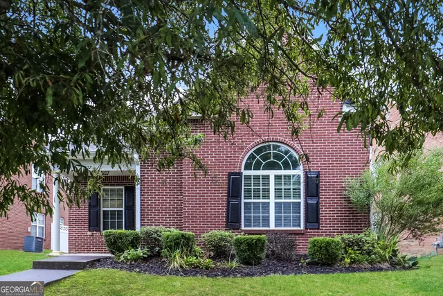 front view of a house with a garden