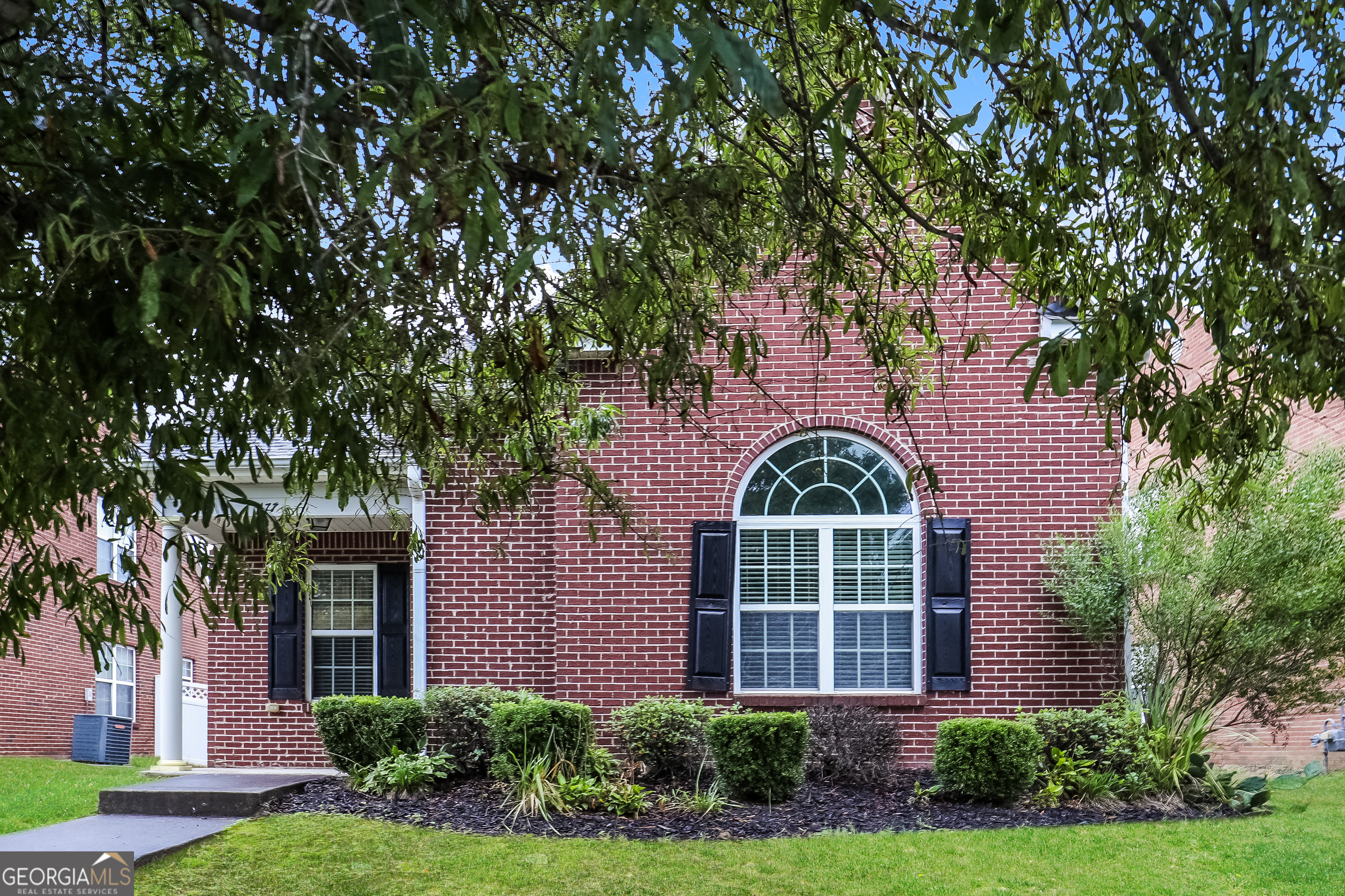 front view of a house with a garden