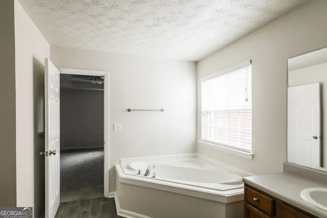 a bathroom with a bathtub and a sink
