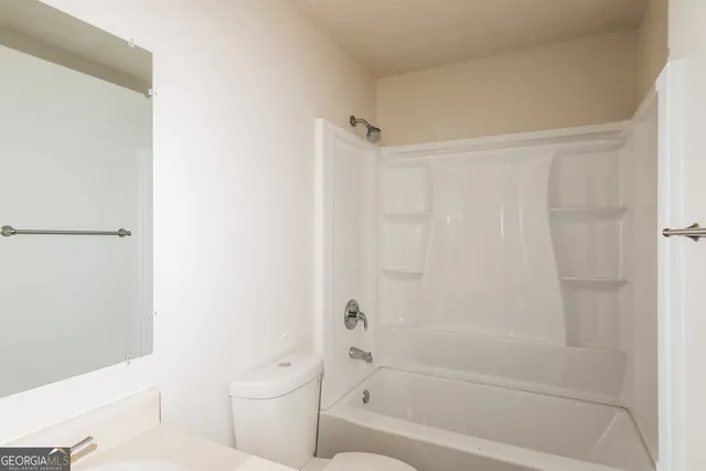 a bathroom with a bathtub and a toilet