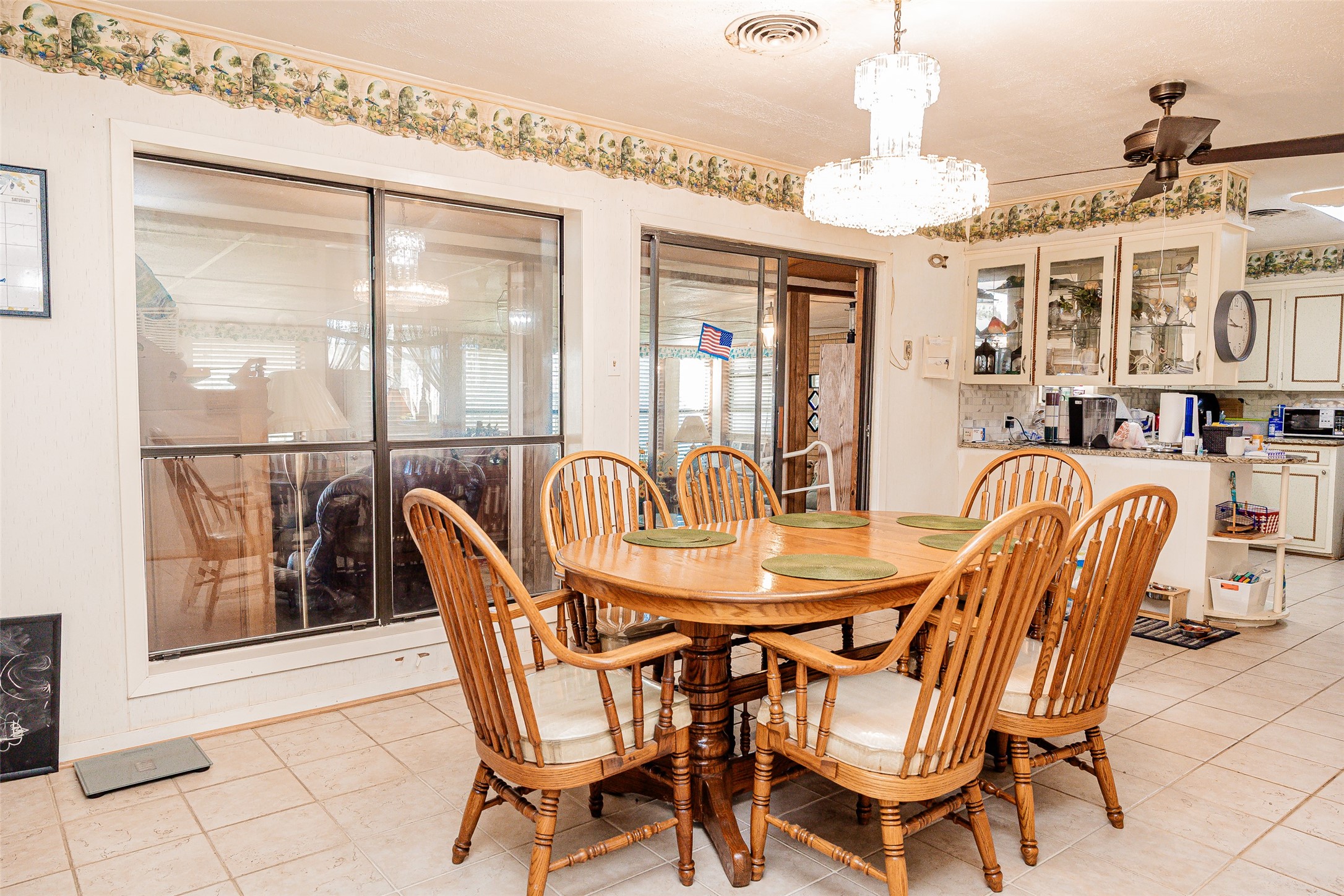 8608 Captain Scott Road Brenham, TX 77833 - Photo 6 of 28 a dining room with furniture a chandelier and wooden floor