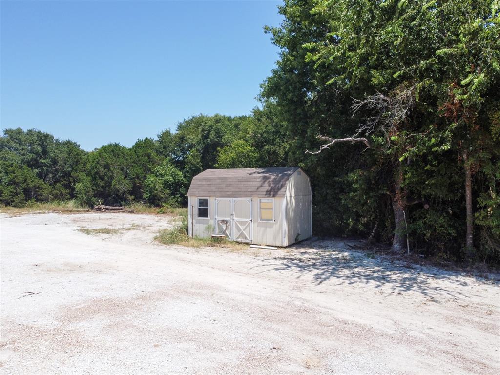 103 Sharon Street Whitney, TX 76692 - Photo 6 of 23 a white house that has a tree in front of it