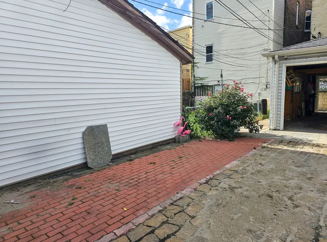 a backyard of a house with flower plants