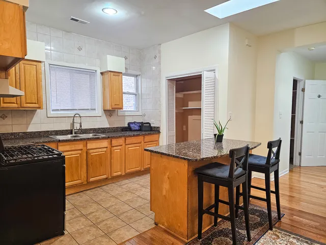 a kitchen with granite countertop a sink and cabinets