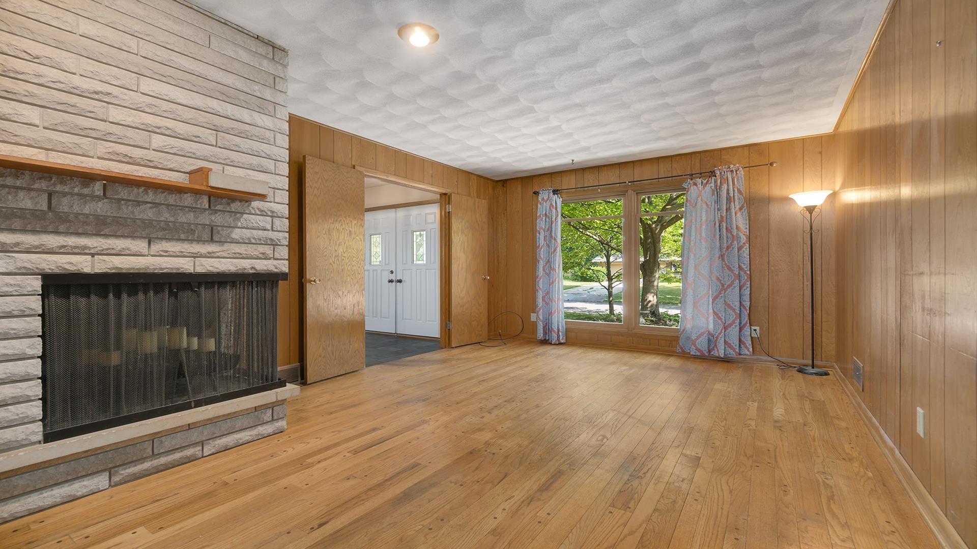4644 Pepper Drive Rockford, IL 61114 - Photo 11 of 45 a view of empty room with wooden floor and fireplace