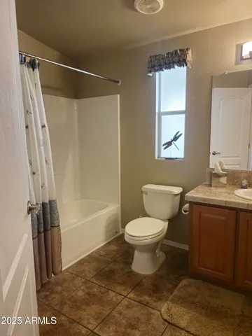 a bathroom with a shower and a sink