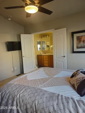 a bedroom with a bed and a television