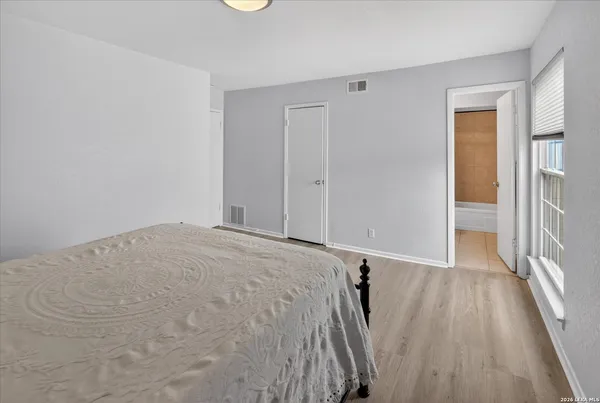 a view of a room with wooden floor and a balcony